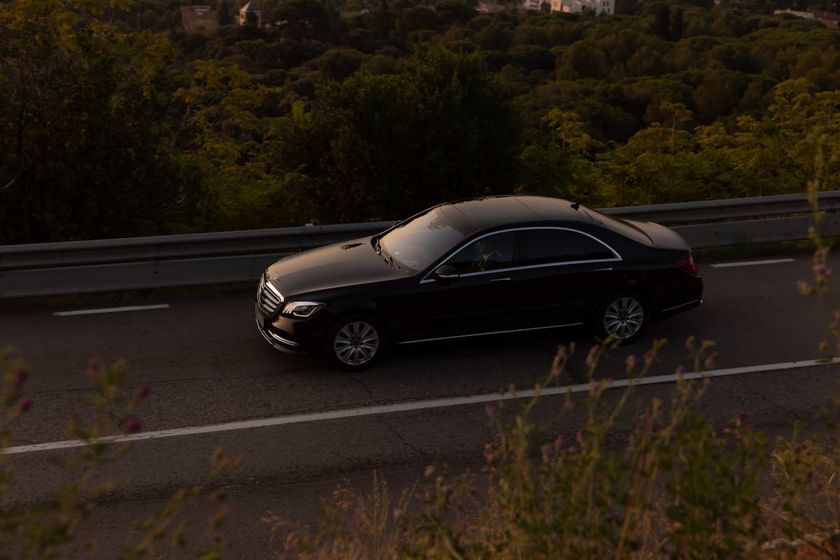 Selena Transfer — black luxury sedan in transit